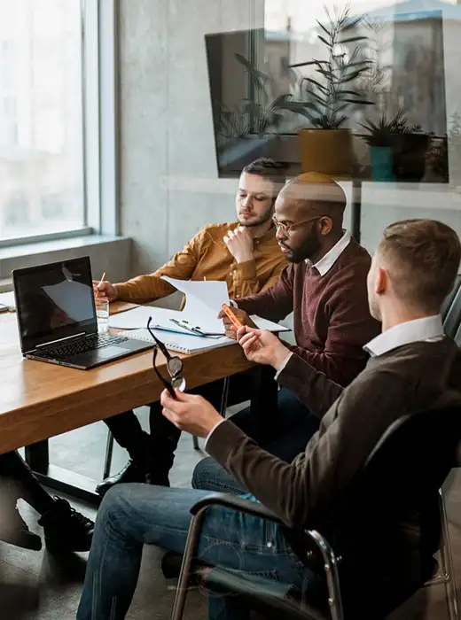 Team discussing a website design at a meeting table