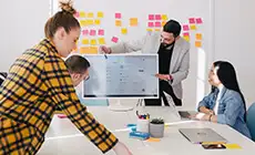 Brainstorming session with sticky notes on a glass wall